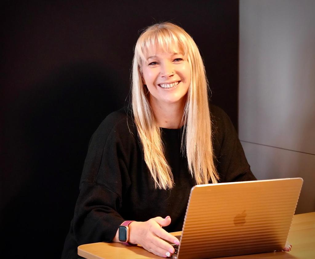 Becky Stone, eating disorder therapist, working on her laptop while writing about the cost of putting yourself out there on social media as a therapist